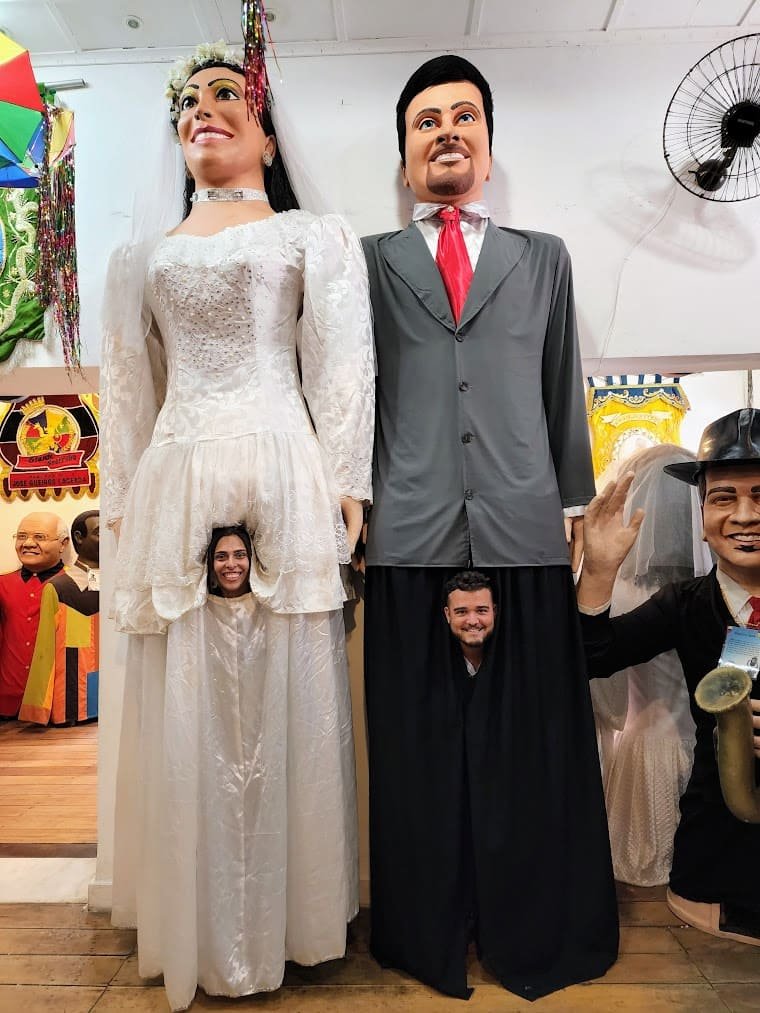Camila e Luã com os bonecos de Olinda